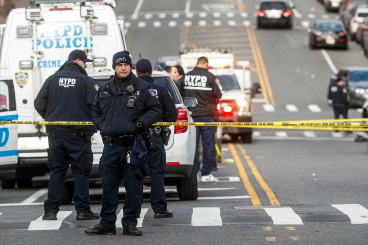 New York City police officers work the scene of a police-involved shooting outside the 41st precinct Sunday morning.