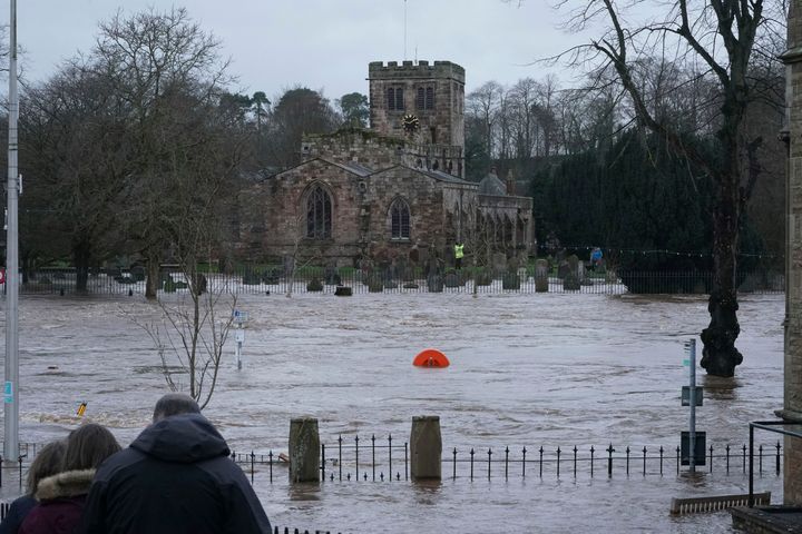 A view of a flooded street, in Appleby-in-Westmorland, as Storm Ciara hits the UK, in Cumbria, England, Sunday Feb. 9, 2020. Trains, flights and ferries have been cancelled and weather warnings issued across the United Kingdom as a storm with hurricane-force winds up to 80 mph (129 kph) batters the region. (Owen Humphreys/PA via AP)