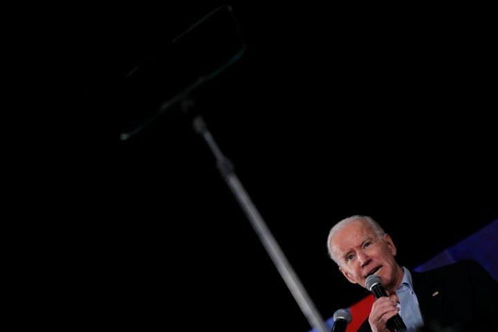 Democratic 2020 presidential candidate and former Vice President Joe Biden looks at a teleprompter as he speaks during a camp