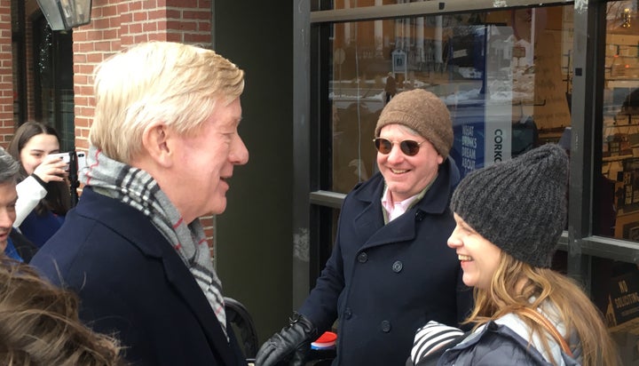 Former Massachusetts Gov. Bill Weld greets pedestrians in Exeter, New Hampshire, on Sunday, closing out a weekend of campaigning ahead of Tuesday's presidential primary. Weld is challenging President Donald Trump for the GOP nomination.