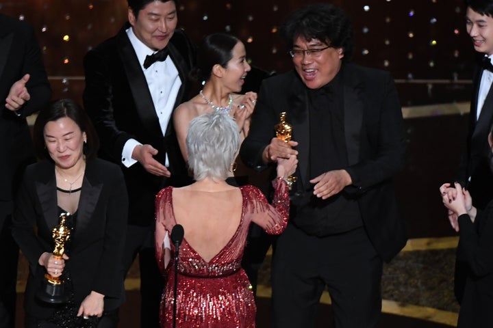 Kwak Sin-ae and Bong Joon Ho are greeted by Jane Fonda as they accept the award for Best Picture for "Parasite."