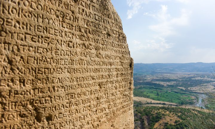 Ancient Greek writing chiselled on stone