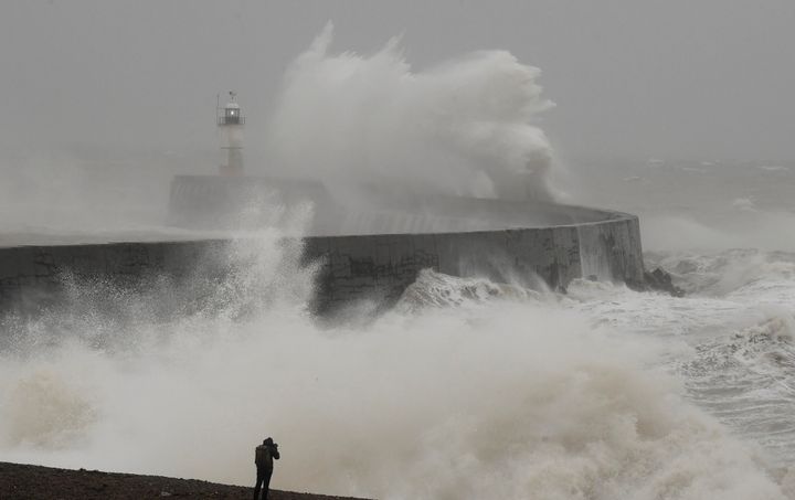 A man photographs large waves caused by Storm Ciara as they hit the the seafront and wall in Newhaven, Britain February 9, 2020. REUTERS/Toby Melville