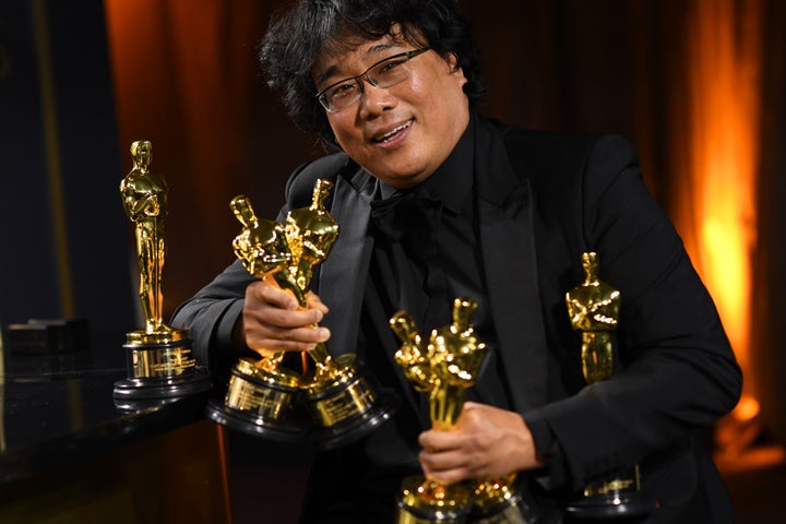 South Korean film director Bong Joon Ho poses with his engraved awards as he attends the 92nd Oscars Governors Ball.