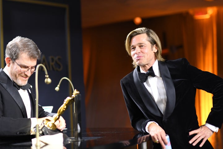 Brad Pitt waits for his award for Best Actor in a Supporting Role to be engraved as he attends the 92nd Oscars Governors Ball.