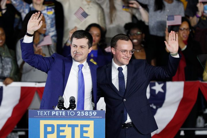 Democratic presidential candidate Pete Buttigieg, left, waves with his husband Chasten Buttigieg after declaring victory in Iowa on Feb. 3, despite the absence of complete results.