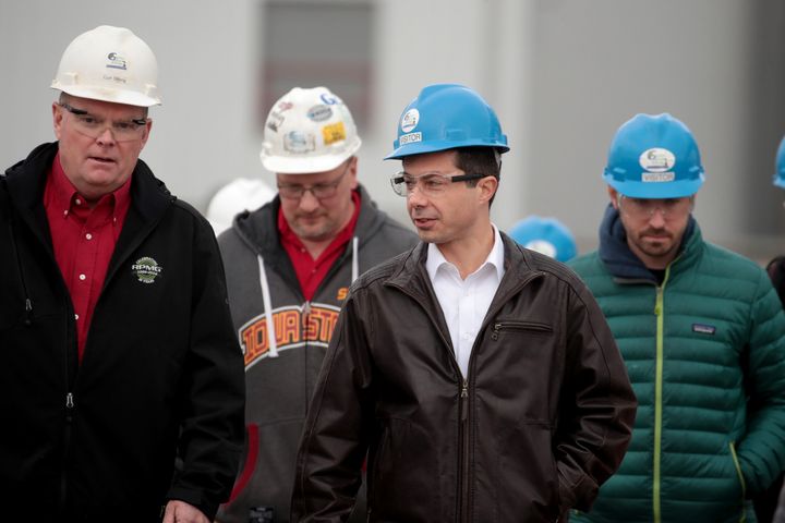 Pete Buttigieg, center, exits a tour of an ethanol plant in Mason City, Iowa, in early November. Courting rural voters was a key element of his approach in Iowa.