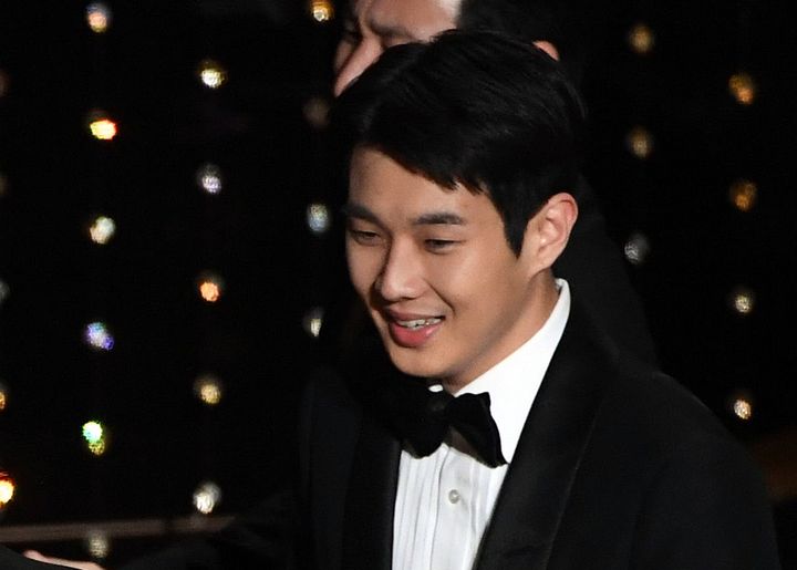 Choi Woo-shik accepts the Best Picture award for 'Parasite' onstage during the Academy Awards on Feb. 9, 2020 in Hollywood, Calif.