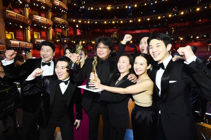 The "Parasite" team pose with their newly won Oscars. Choi Woo-shik is on the far right.