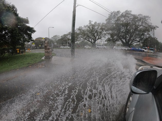 SYDNEY, AUSTRALIA - FEBRUARY 09: A car goes through flooding on Anzac Parade on February 09, 2020 in Sydney, Australia. The Bureau of Meteorology has forecast heavy rainfall across Sydney this weekend and issued a severe weather warning for dangerous winds, heavy rainfall and coastal erosion from abnormally high tides and damaging surf. (Photo by Mark Evans/Getty Images)