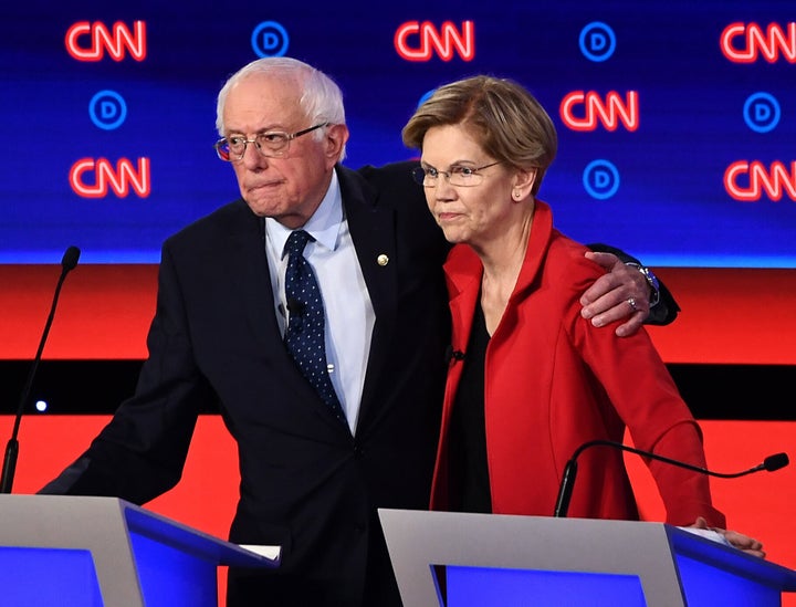 Sen. Bernie Sanders (left) shares a moment with Sen. Elizabeth Warren before the Democratic presidential debate in Detroit in July. The two have been co-endorsed by Common Defense.