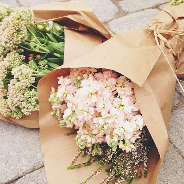 Flowers wrapped in paper, rather than plastic.