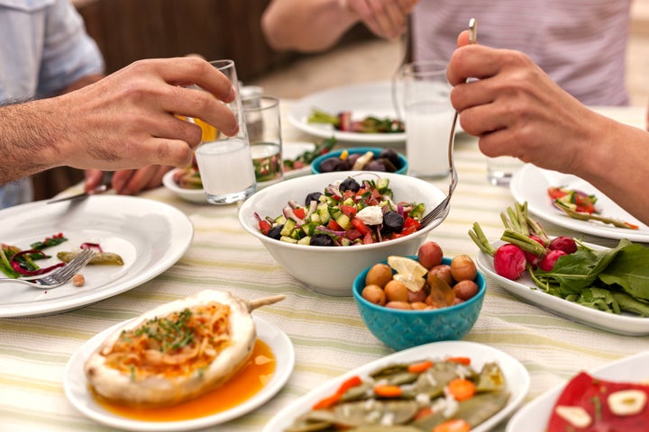 Couple  Eating Lunch with Fresh Salad and Appetizers