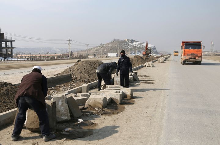 Afghan laborers work on a bridge project funded by the government, in Kabul, Afghanistan, on Feb. 10, 2020.