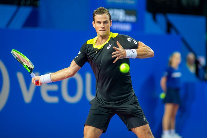 Canadian tennis player Vasek Pospisil competes against David Goffin of Belgium at the Open Sud de France tennis tournament on Saturday in Montpellier, France. The 29-year-old calls maple syrup the "best sports performance drink" after he was caught slurping the stuff on a tennis court.