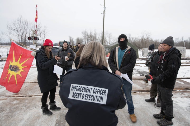 An Enforcement Officer reads the Injunction to members of the Tyendinaga Mohawk Territory in Tyendinaga Mohawk Territory, near Belleville, Ont., on Feb. 11, 2020.