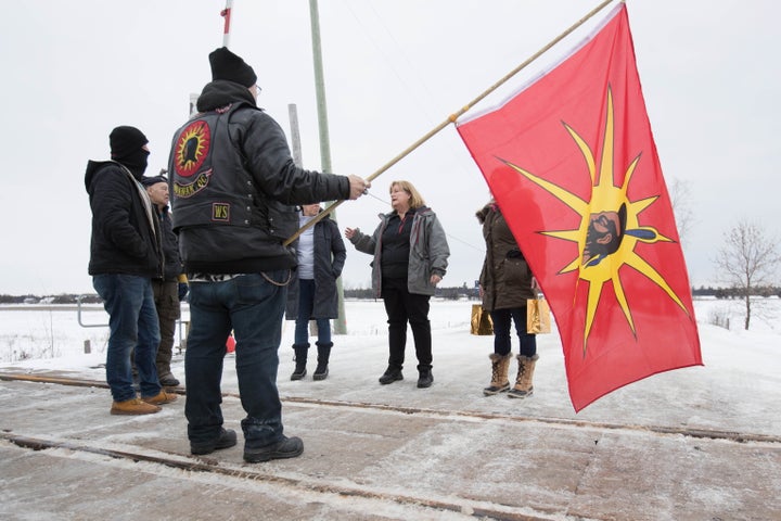 OPP Sgt. Diana Hampson, middle, speaks with members of the Mohawk Territory in Tyendinaga Mohawk Territory, near Belleville, Ont. on Feb. 11, 2020.