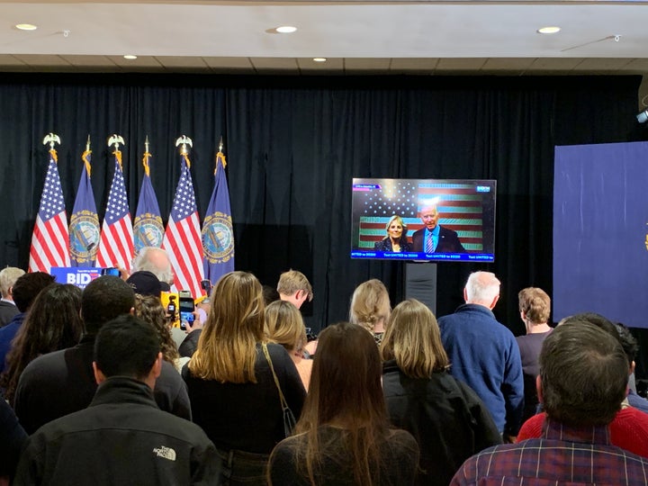Joe Biden supporters listen to the former vice president speak via live stream at his New Hampshire primary party on Tuesday
