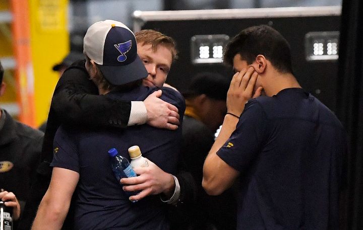 Anaheim Ducks left wing Max Jones, second from right, greets two members of the St. Louis Blues after Blues defenseman Jay Bouwmeester suffered a medical emergency.