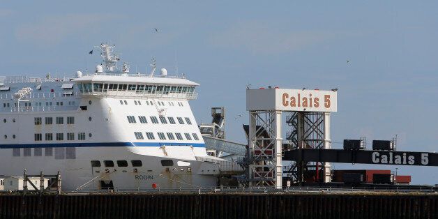 In this Friday, July 31, 2015 photo, a ferry is parked in the port of Calais, France. Calais, with its huge port bringing visitors across the Channel by ferry, its Eurostar train which stops in nearby Frethun and its highways, is a natural hub for travelers, but they are going somewhere else. (AP Photo/Thibault Camus)