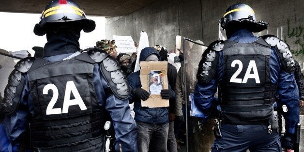 CALAIS, FRANCE - DECEMBER 5, 2015: On Thursday December 3, Youssef (whom various reportage say was aged between 16-22) from Sudan tried to depart the refugee camp in Calais, France dubbed 'the jungle' to attempt to enter the UK. He was allegedly run over by a lorry driver who didn't stop. An ambulance arrived at the scene an hour later, but it was too late and Youssef was pronounced dead. The refugees from the camp in Calais took part in a silent march on December 5, 2015 about Youssef's death,