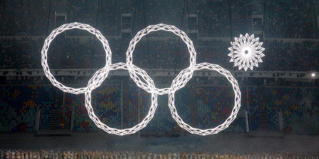 Performers sing as the Olympic rings are presented during the Opening Ceremony of the Sochi Winter Olympics at the Fisht Olympic Stadium on February 7, 2014 in Sochi. AFP PHOTO / YURI KADOBNOV (Photo credit should read YURI KADOBNOV/AFP/Getty Images)