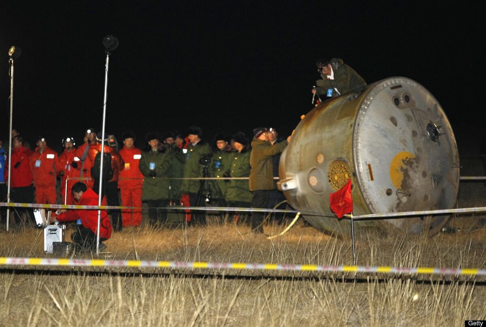A recovery team checks the Shenzhou VIII