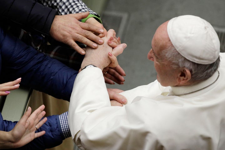 Pope Francis is greeted by faithful during the weekly general audience at the Vatican, Wednesday, Feb. 12, 2020. (AP Photo/Gr