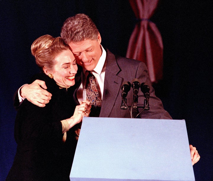 Presidential candidate Bill Clinton hugs his wife at his primary night party in Merrimack, New Hampshire, on Feb. 18, 1992. C