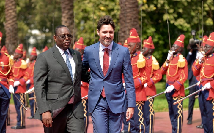 Senegal's President Macky Sall walks alongside Prime Minister Justin Trudeau, upon arrival at the Presidential Palace in Dakar, Senegal, on Feb. 12, 2020.