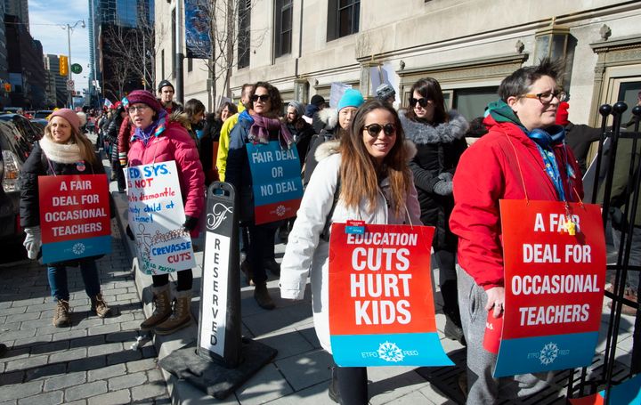 Striking school teachers protest outside a speech by Ontario Education Minister Stephen Lecce in Toronto on Feb. 12, 2020. 
