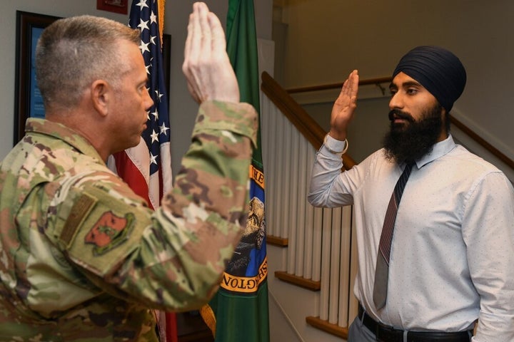 Gurchetan Singh recites the oath of enlistment on Sept. 27, 2019, at Camp Murray in Washington state. Singh is the first Sikh to enlist in the Air National Guard with a religious accommodation wavier that allows him to serve and still practice key elements of his religion.