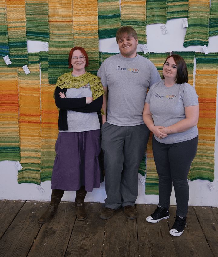 Tempestry Project co-founders Emily McNeil (left), Justin Connelly (centre) and Marissa Connelly (right) display tempestries at Deception Pass, in Washington, U.S.