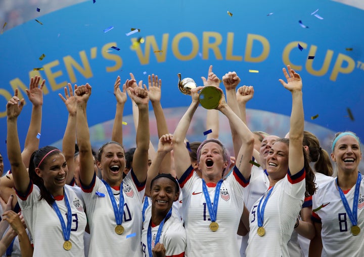 FILE - In this July 7, 2019, file photo, United States' Megan Rapinoe lifts up a trophy after winning the Women's World Cup f