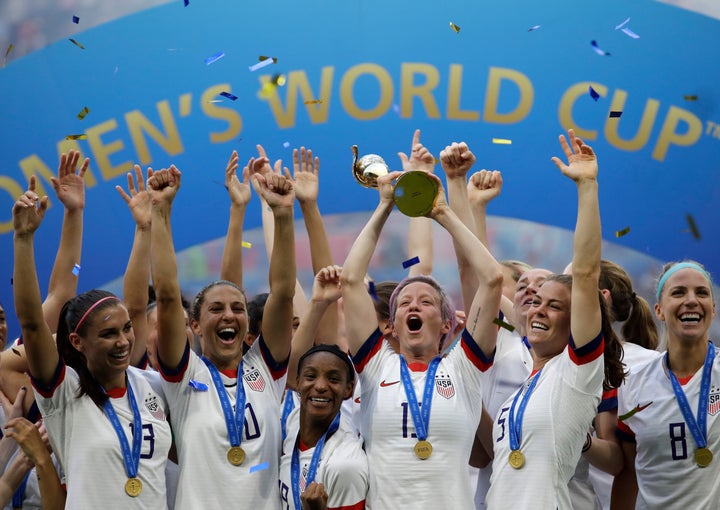 FILE - In this July 7, 2019, file photo, United States' Megan Rapinoe lifts up a trophy after winning the Women's World Cup final soccer match between U.S. and The Netherlands at the Stade de Lyon in Decines, outside Lyon, France. 