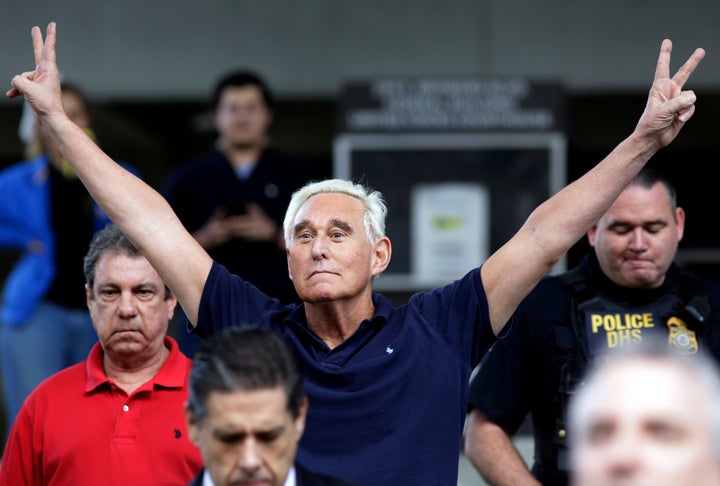 Stone exits a federal courthouse after his indictment on obstruction and lying to Congress. He flashes the double V signal, usually used to symbolize victory or peace.