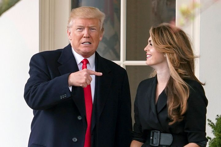 President Donald Trump points to outgoing White House communications director Hope Hicks on her last day before he boards Marine One on the South Lawn of the White House in Washington.