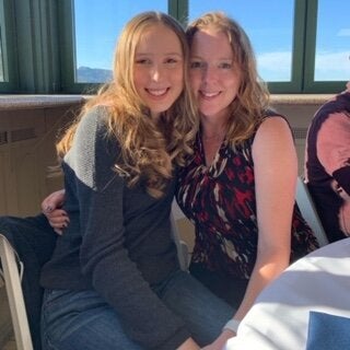 Stephanie (right) and her daughter at a wedding several months ago. They had to leave a few hours in because her daughter was in pain.