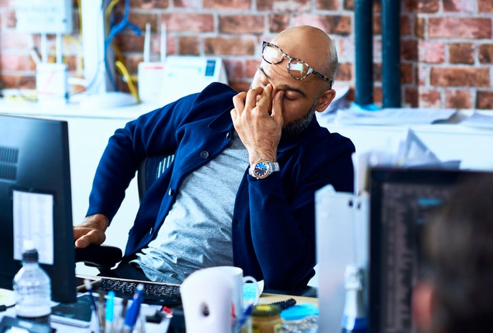 In this stock photo, a worker sits at his desk during a long shift at the office. Before Family Day was introduced in 2008, Ontario workers had no public holidays between New Year’s Day and Good Friday.