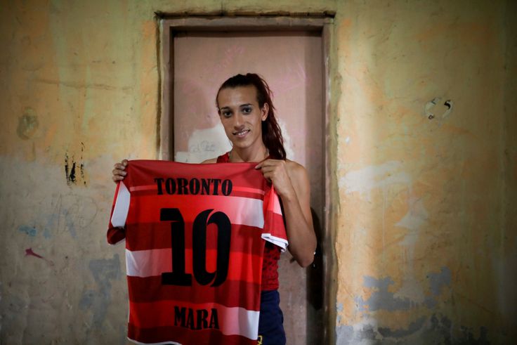 Gomez poses with her old jersey from the first amateur soccer club she played for, Toronto. 
