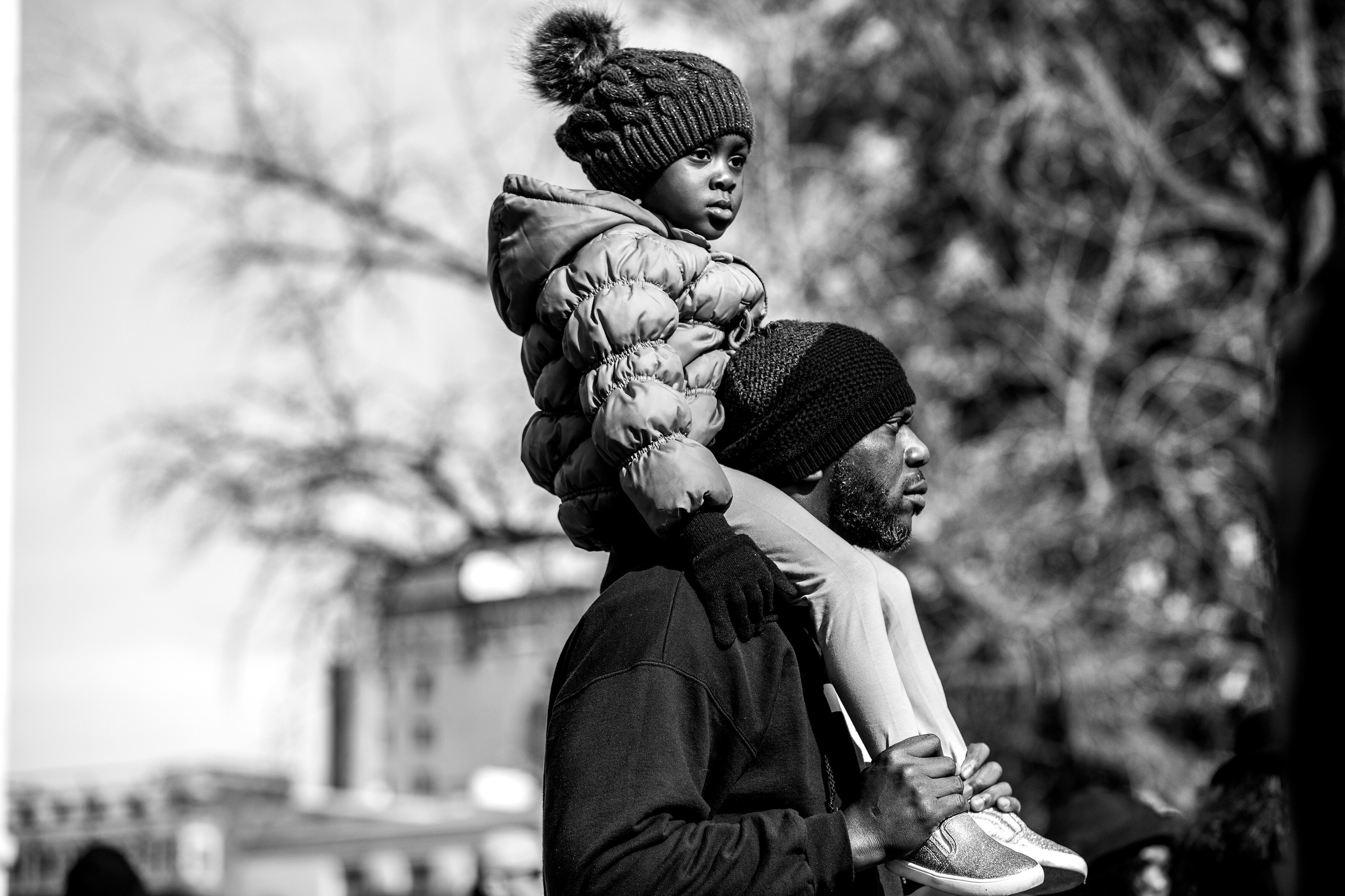 Lester Young, 47, and his daughter Kaleeyah, 4, listen to the 2020 Democratic candidates during the MLK Day celebration at the South Carolina Statehouse in Columbia, South Carolina.