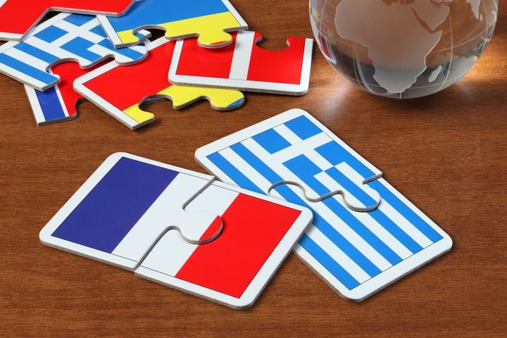 puzzle with the national flag of French and Greece on wooden table