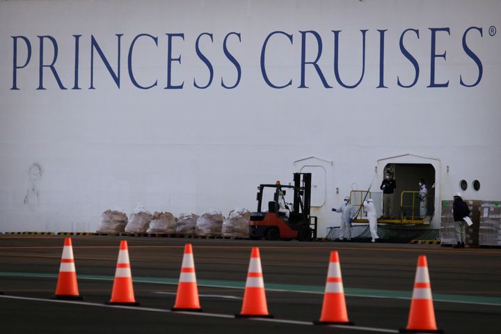 Workers load supplies onto the quarantined Diamond Princess cruise ship in Yokohama