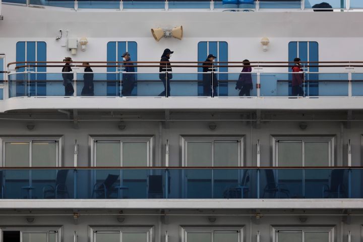 A group of quarantined passengers exercise on the Diamond Princess cruise ship Saturday, Feb. 15, 2020, in Yokohama, near Tokyo. A viral outbreak that began in China has infected more than 67,000 people globally. The World Health Organization has named the illness COVID-19, referring to its origin late last year and the coronavirus that causes it. (AP Photo/Jae C. Hong)