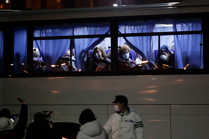 Buses carrying American passengers from the quarantined Diamond Princess cruise ship leave a port in Yokohama, near Tokyo, on Monday.