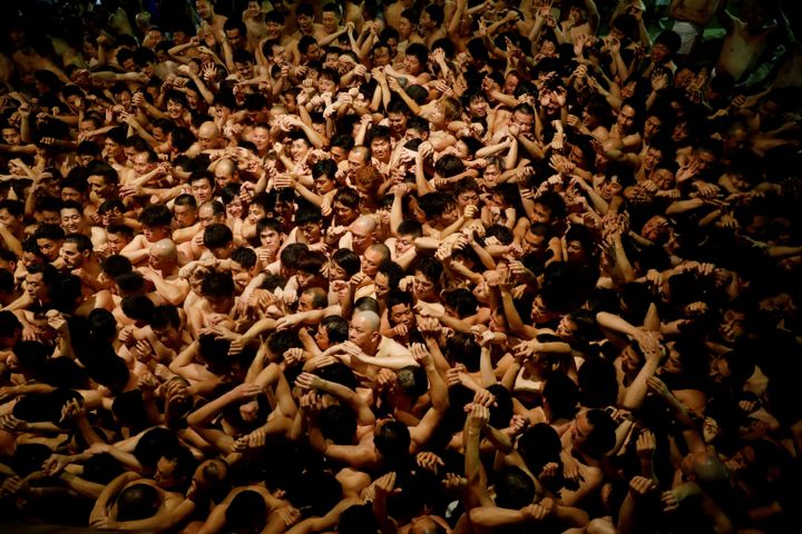 Men dressed in loincloths prepare to snatch a wooden stick called "shingi" tossed by the priest during a naked festival at Saidaiji Temple in Okayama, Japan, on February 15, 2020. 