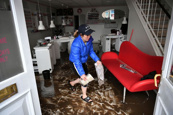 An employee cleans a nail salon, after Storm Dennis hits the UK leading to widespread flooding, in Pontypridd, Wales.