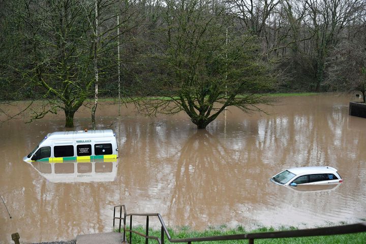 An ambulance, left, and a vehicle are submerged after flooding in Nantgarw, Wales.