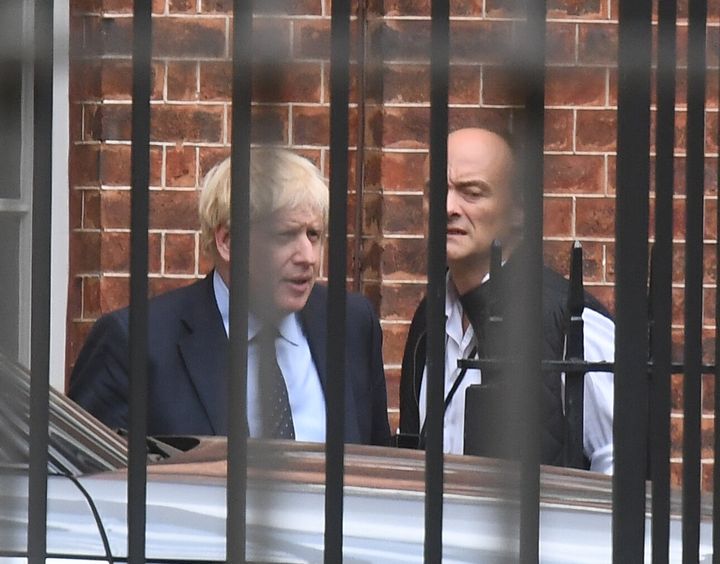Prime minister Boris Johnson with his senior aide Dominic Cummings as they leave Downing Street, central London.