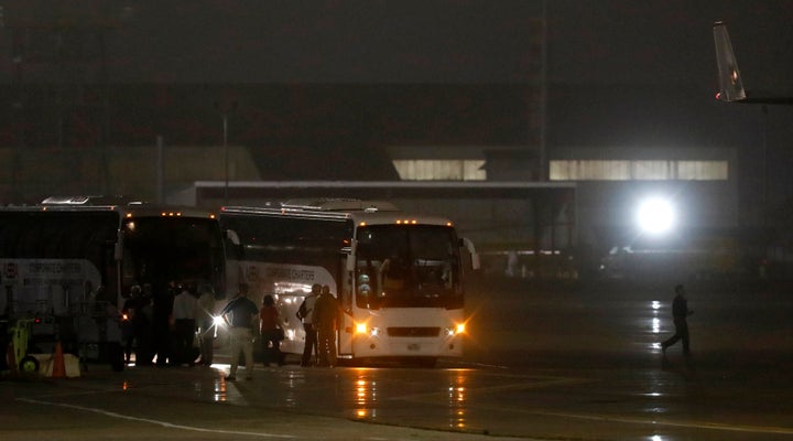 American evacuees from the Diamond Princess cruise ship board buses at Joint Base San Antonio-Lackland on Monday in San Antonio, Texas. 